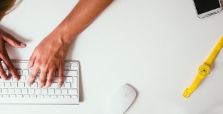 Person working at their desk and using their laptop