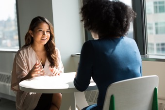 Two women sitting opposite each other during an interview